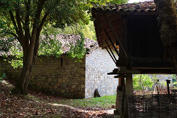 Parte posterior de la casa de campesinos con su hórreo en museo del pueblo de Asturias en Gijón