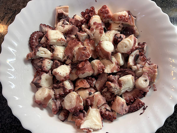 Pulpo cocido y troceado para preparar pulpu de pedreru con patatines